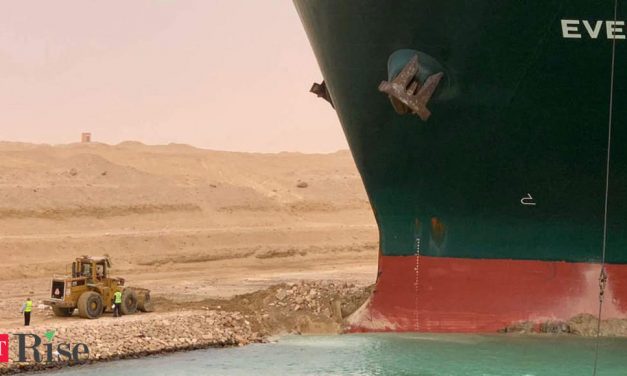 Tugs work to free ship stranded in Suez Canal