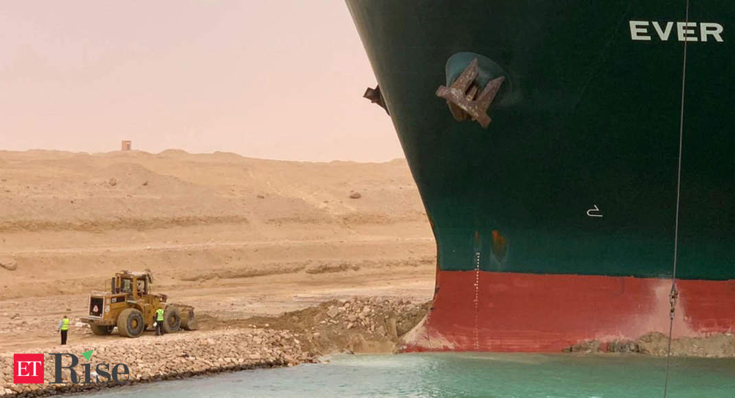 Tugs work to free ship stranded in Suez Canal